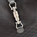Gucci tote bag hardware detail with clasp and metal rings on dark fabric strap