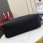 Gucci tote bag bottom view with dark gray exterior and flat, rounded base