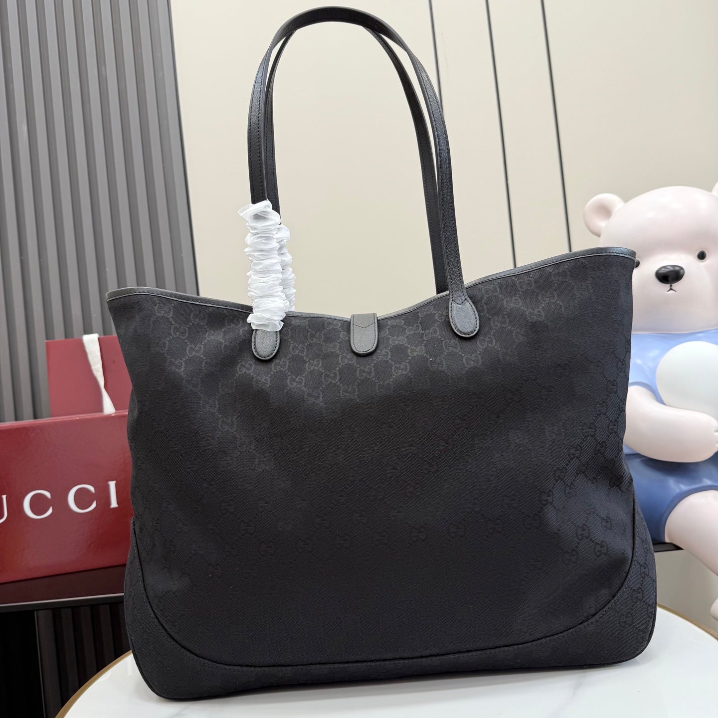 Gucci tote bag with dark gray patterned canvas and top handles with fabric tie detail