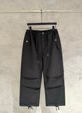 Black wide-leg pants with elastic waistband, drawstring ties and cargo pocket panels