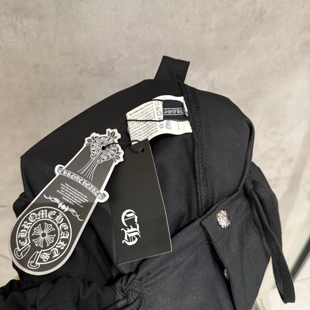 Black pants on hanger with fabric label and drawstring tie