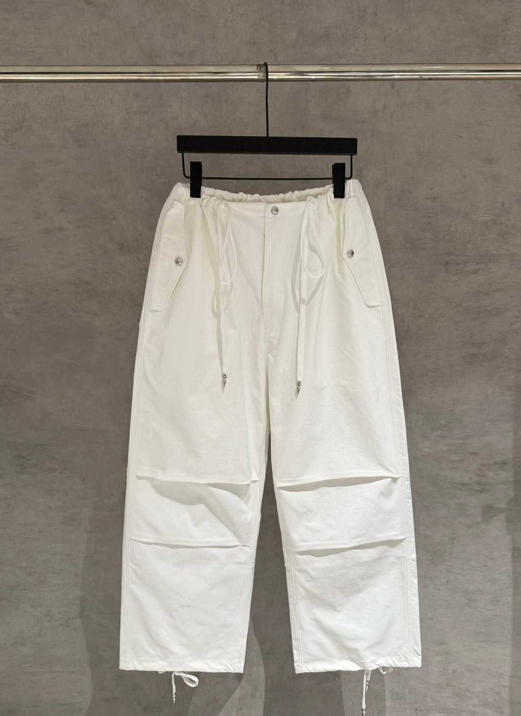 White drawstring cargo pants with elastic waist and side pockets