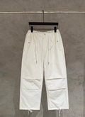 White drawstring cargo pants with elastic waist and side pockets