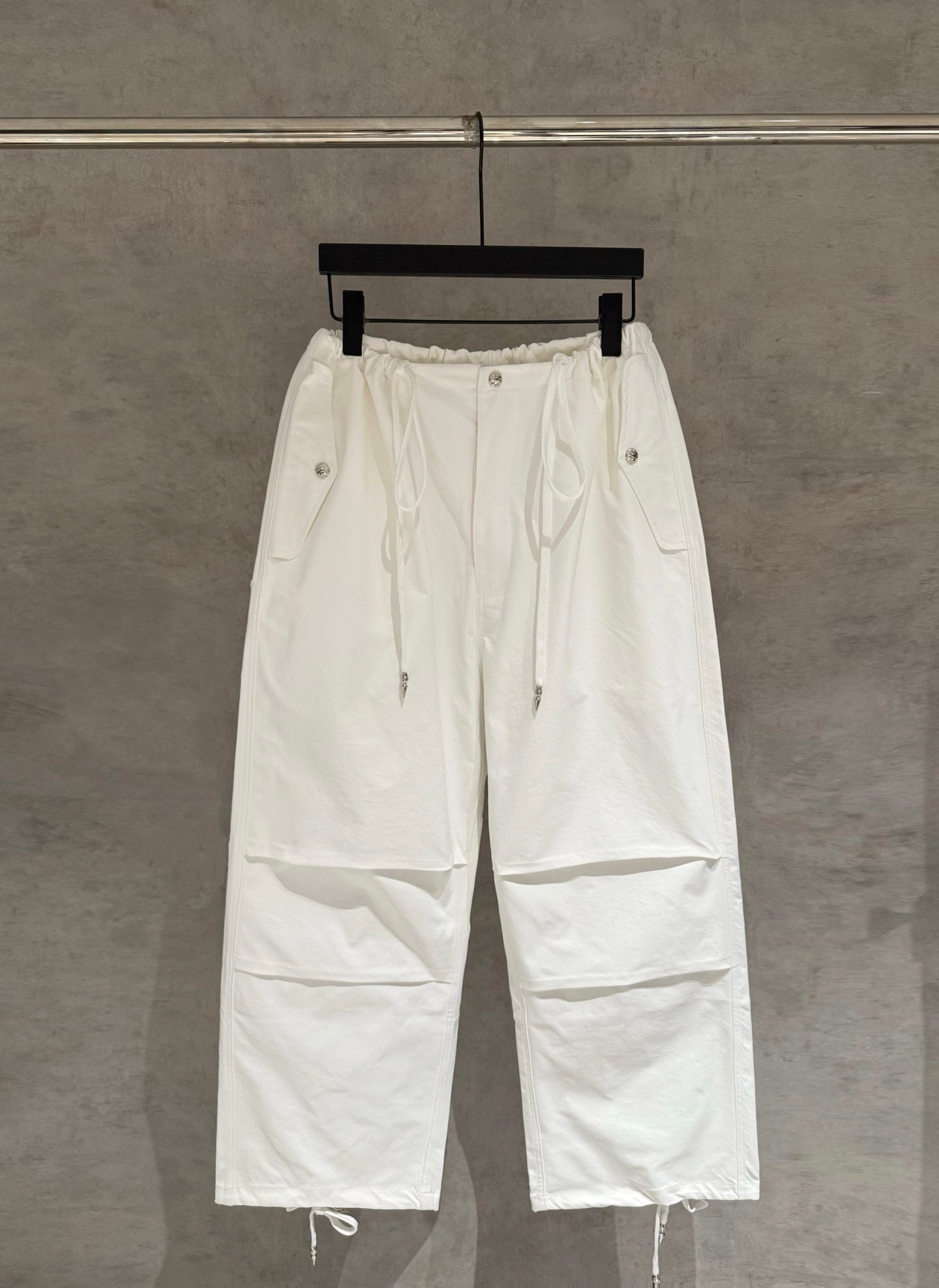 White drawstring cargo pants with elastic waist and side pockets