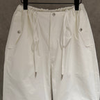 White elastic-waist cargo pants with drawstring and front metal button details