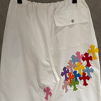 White cargo pants with side pocket flap and multicolor cross applique decoration