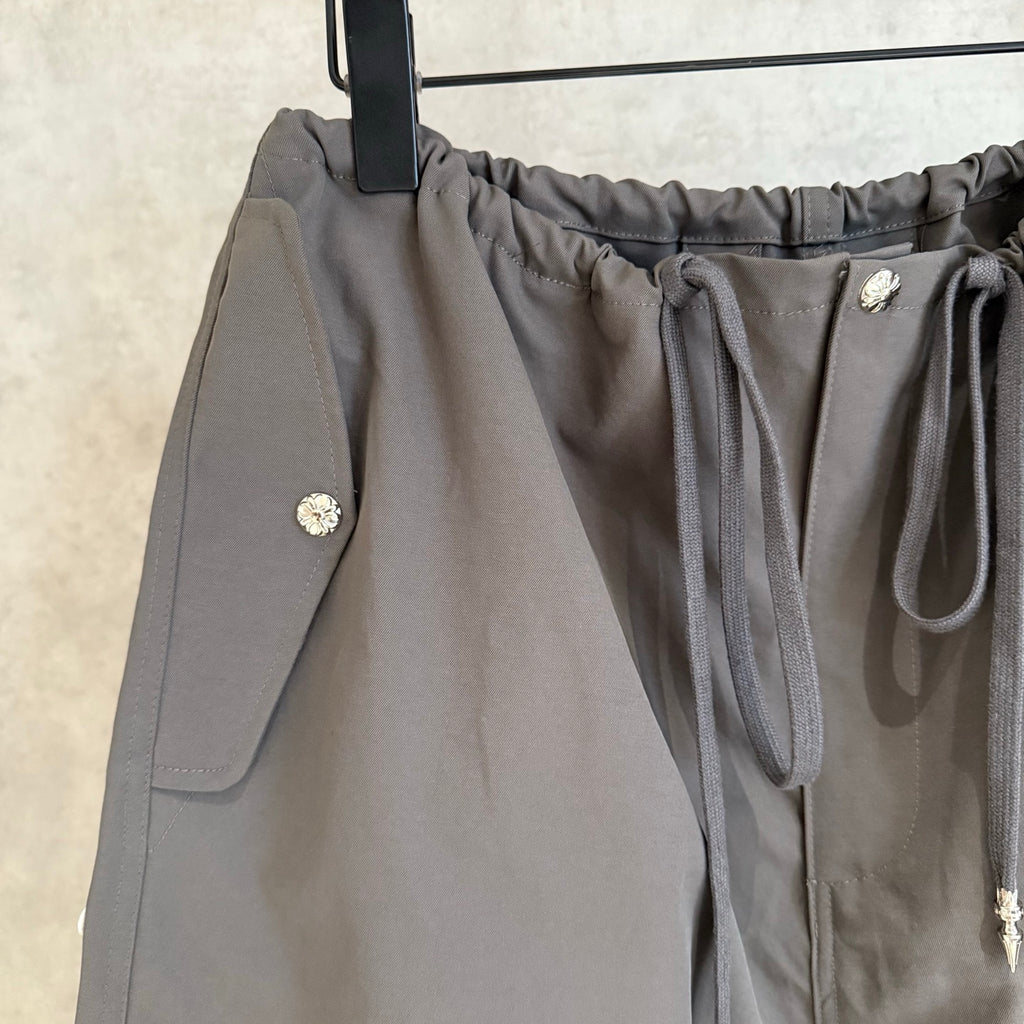Chrome pants in dark gray with drawstring tie, side pockets, snap detail