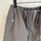Chrome pants in dark gray with drawstring tie, side pockets, snap detail