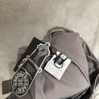 Taupe pants with drawstring waistband and attached clothing tag