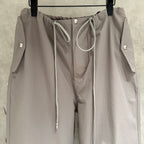 Taupe drawstring pants with front tie and logo snap buttons