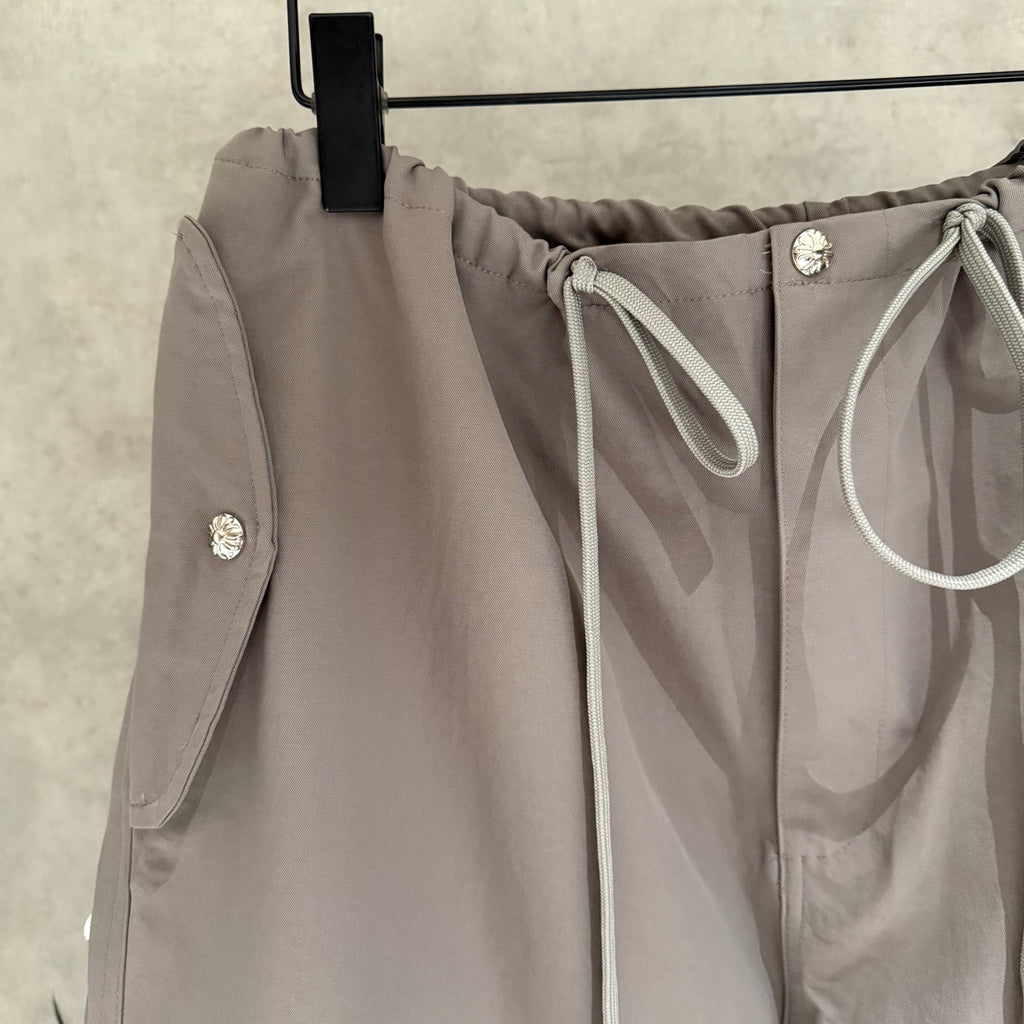 Taupe drawstring pants with front tie and side pocket detailing