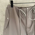 Taupe drawstring pants with front tie and side pocket detailing