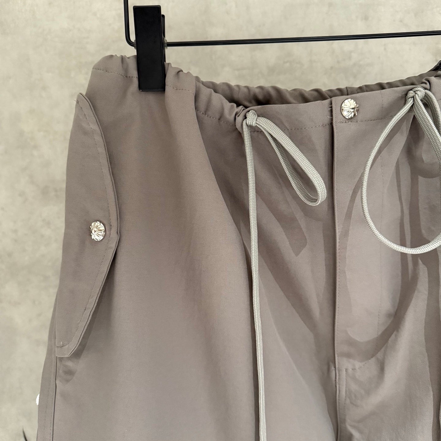 Taupe drawstring pants with front tie and side pocket detailing