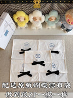 Set of white Prada gift bags with black bows and circular logo labels