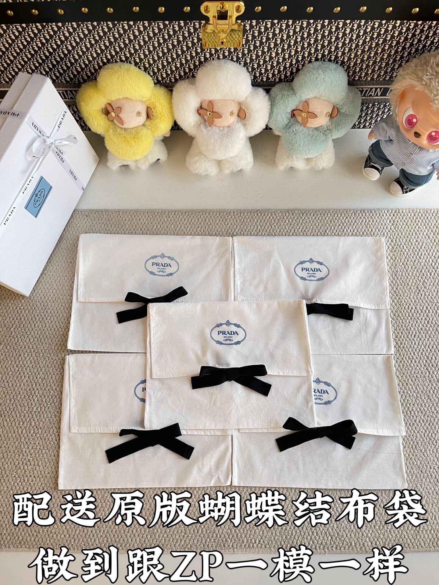 Set of white Prada gift bags with black bows and circular logo labels