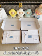 Prada pants shoebox-style packaging with labels and tissue bags