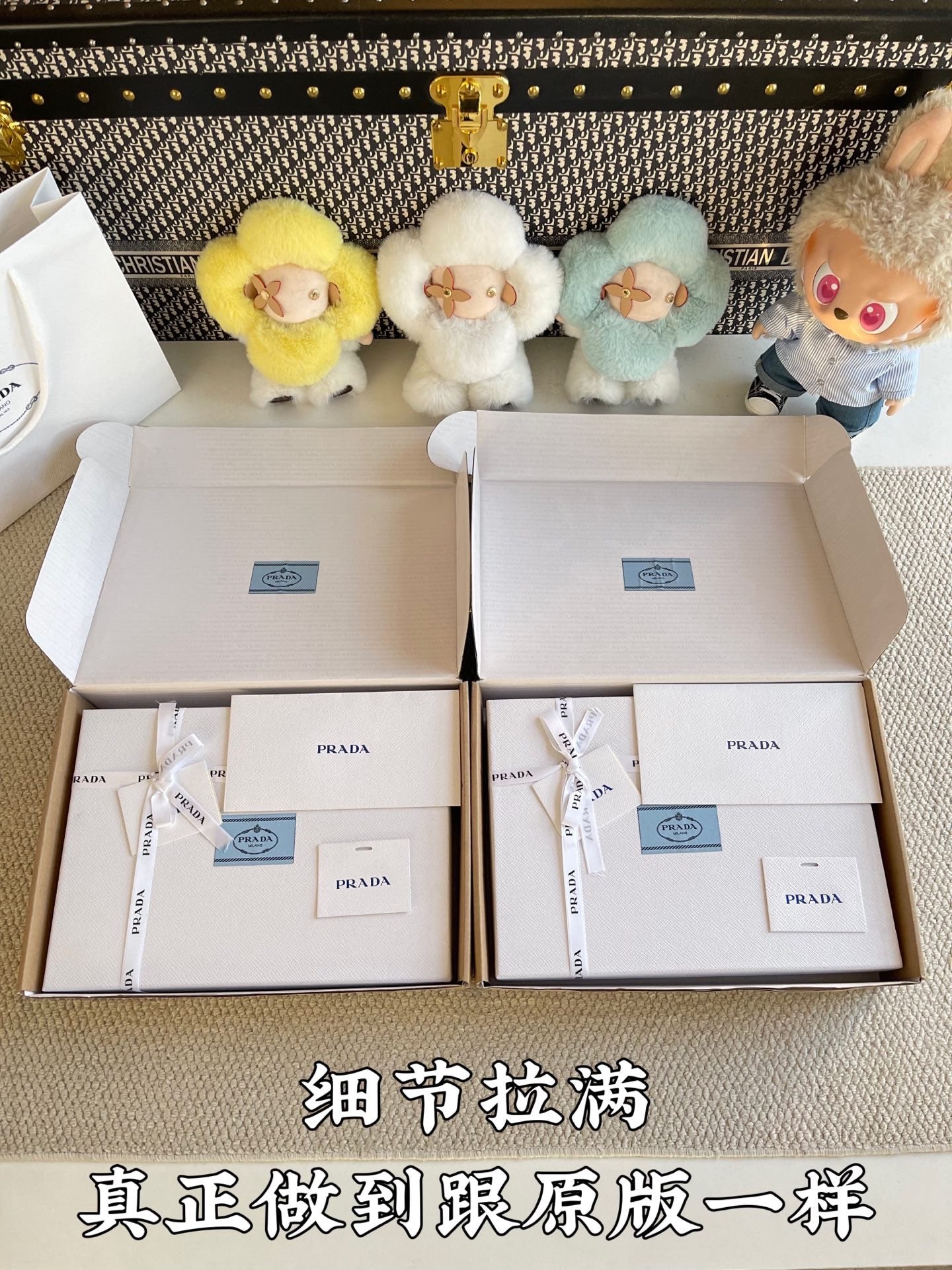 Prada pants shoebox-style packaging with labels and tissue bags