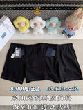 Black shorts with belt loops, front pockets, and zip fly; tags attached at left leg