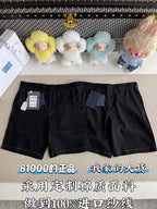 Black shorts with belt loops, front pockets, and zip fly; tags attached at left leg