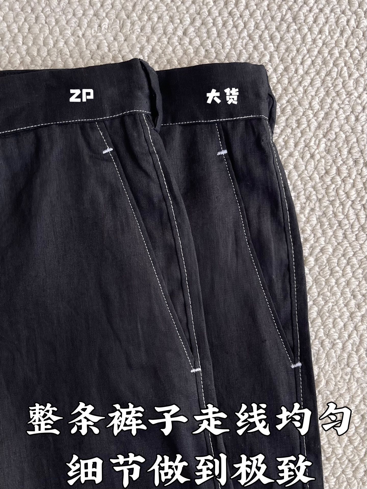 Black denim-style shorts with zip fly, belt loops, and visible contrast seams