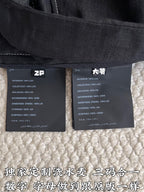 Black shorts fabric care labels inside waistband; material content tags visible