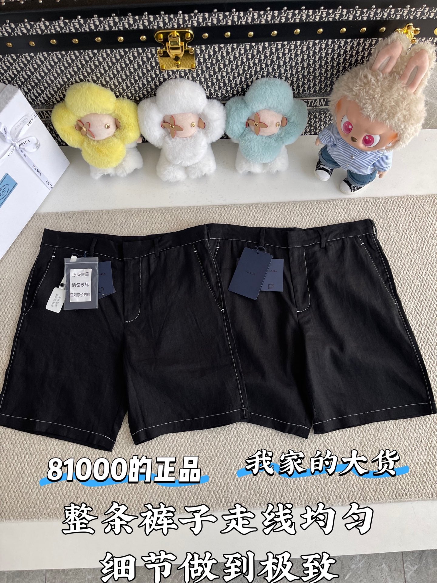 Black shorts laid flat with belt loops, front pockets, and zip fly; size tag on waist