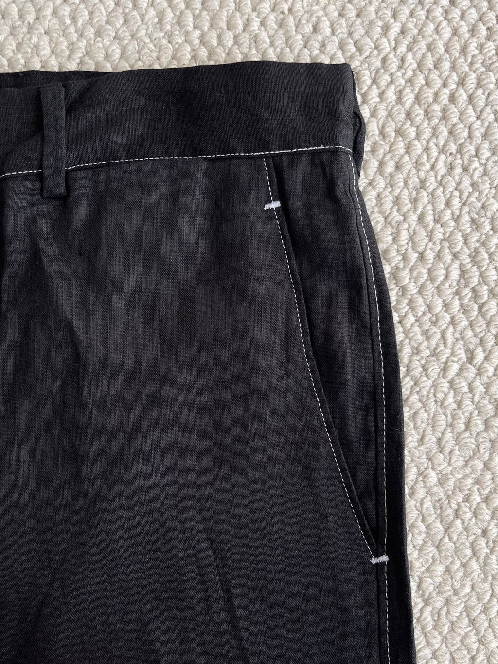 Prada black pants close-up of side pocket and contrast stitching