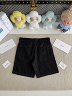 Prada black shorts-style pants with belt loops and front pockets, angled view