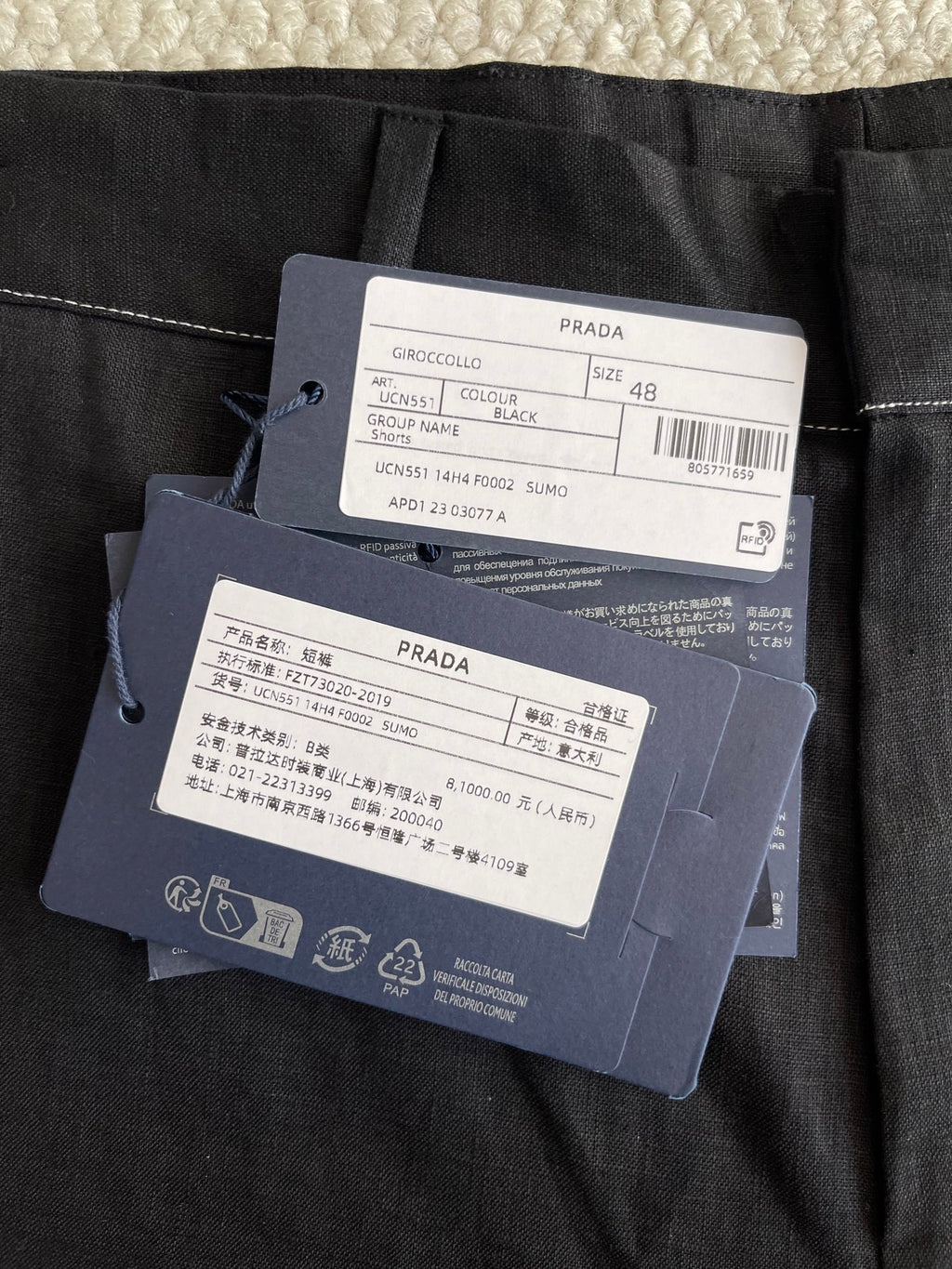 Prada black pants fabric with size and material tags