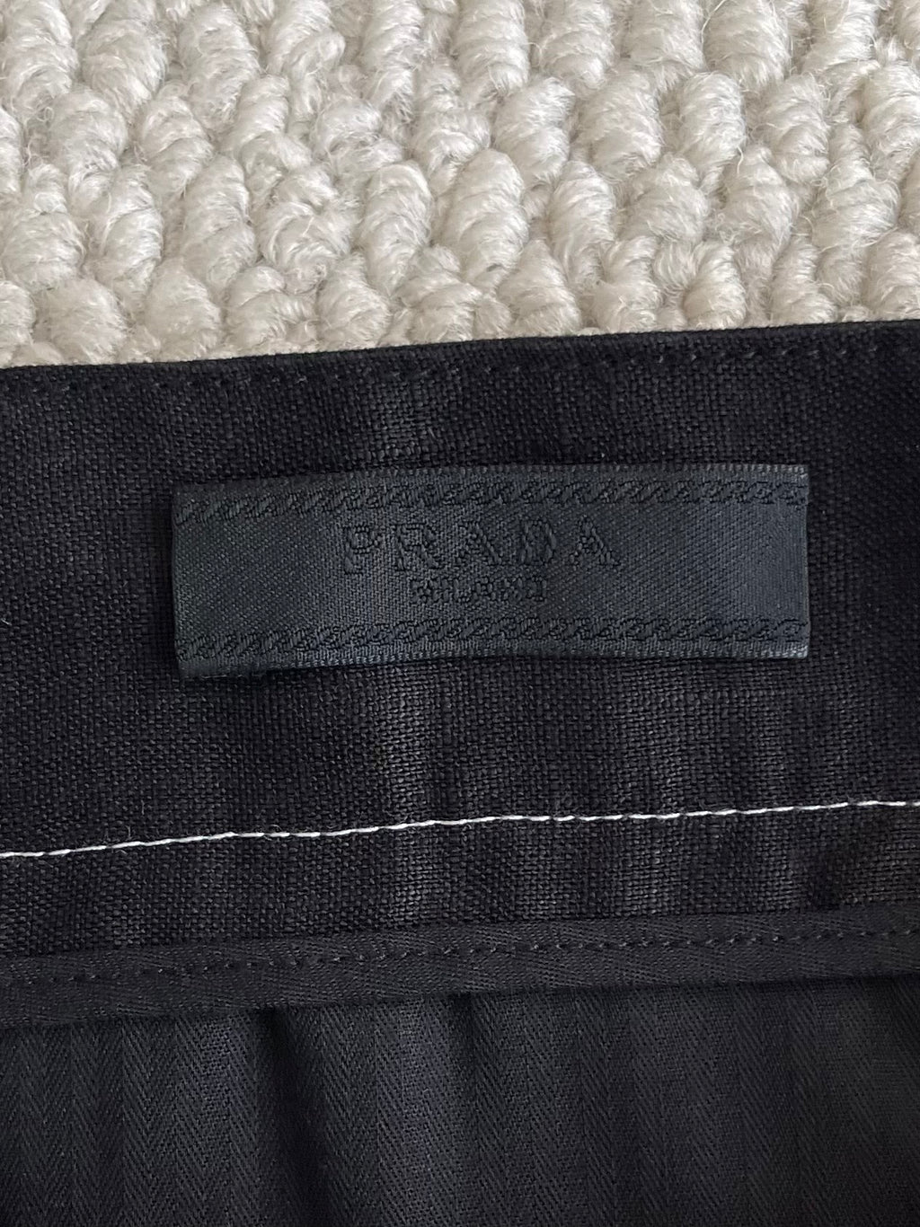 Prada black pants waistband label with embossed logo