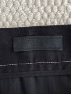 Prada black pants waistband label with embossed logo