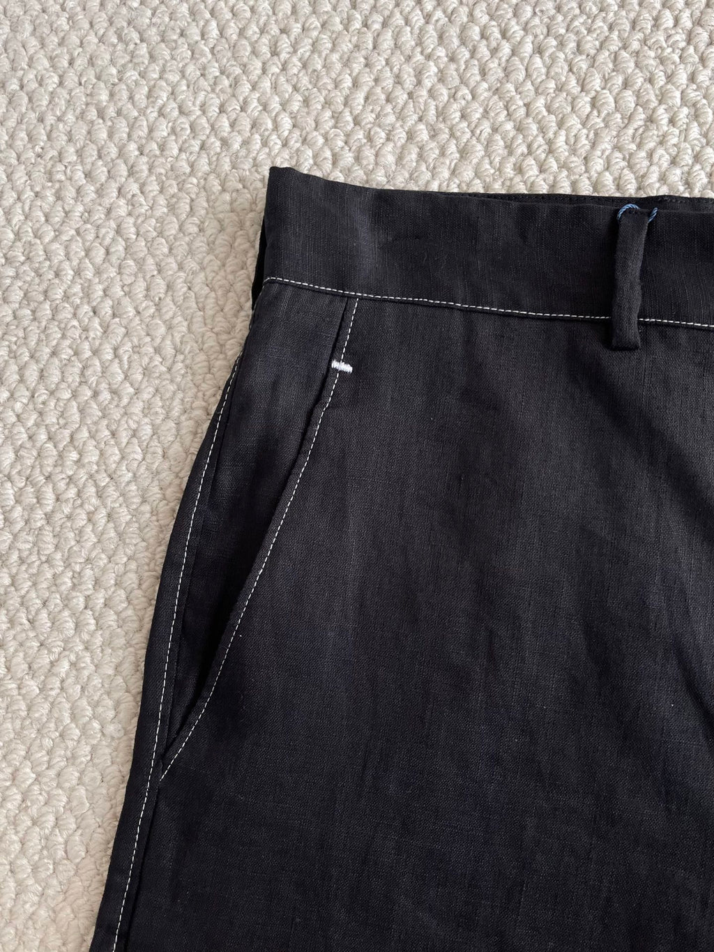 Prada black pants close-up of side seam and stitched pocket opening