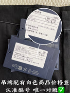 Prada pants with circular size label and attached care info tags