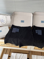 Prada black shorts front view with zip fly, belt loops, small branded tag