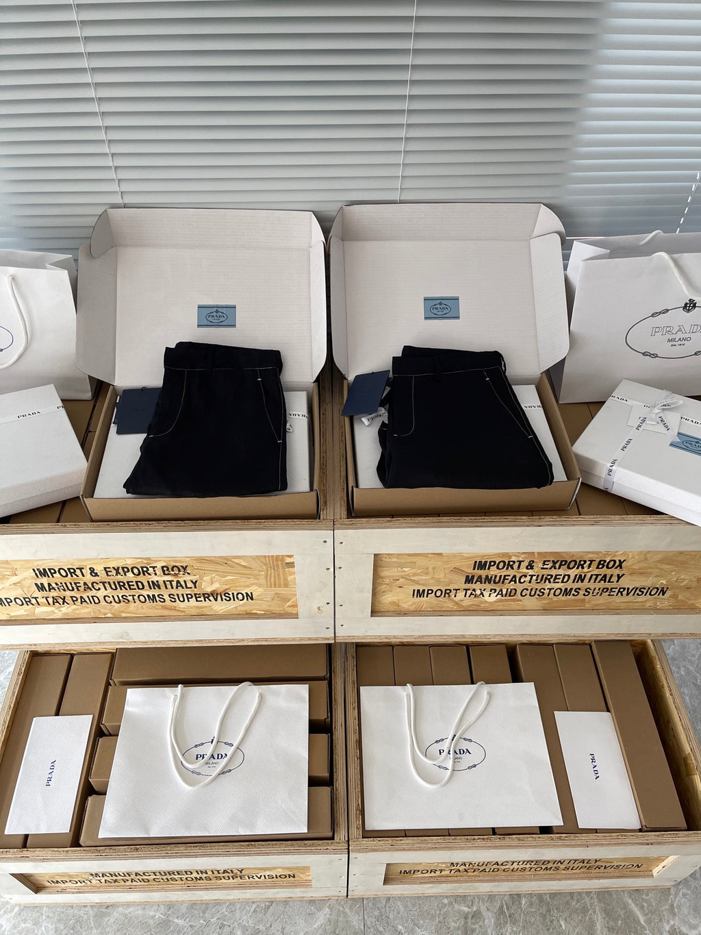 Prada black shorts in boxes, front view with belt loops and stitched pockets