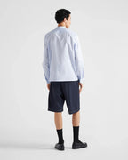 Navy Prada shorts from behind, knee-length hem and front-to-back seams