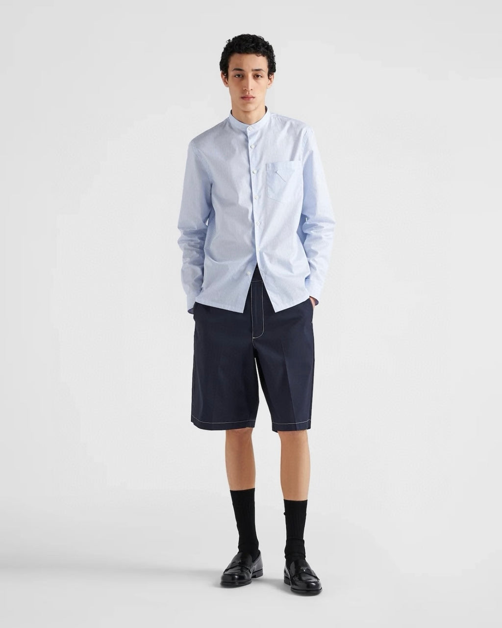 Navy Prada shorts with front button closure, straight hem and seam lines