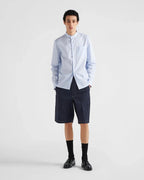 Navy Prada shorts with front button closure, straight hem and seam lines
