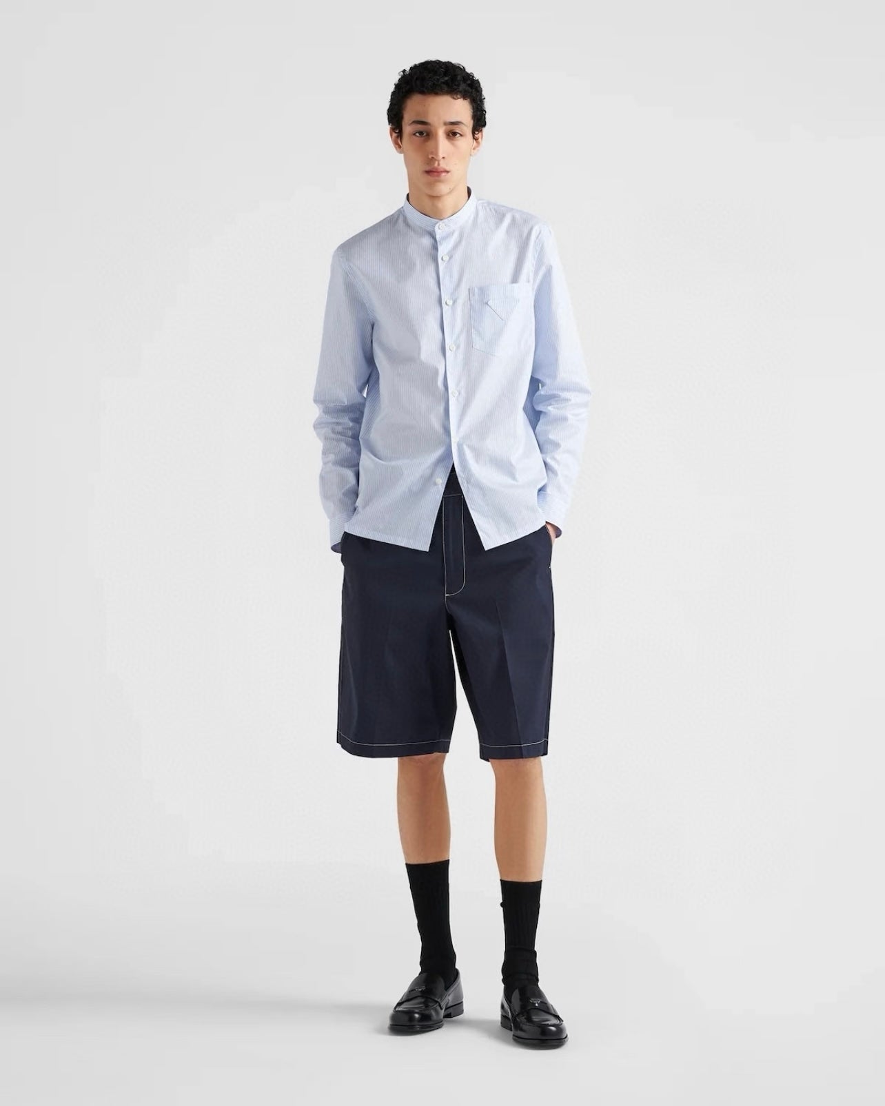 Navy Prada shorts with front button closure, straight hem and seam lines