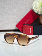 Prada glasses with tortoiseshell frames and warm brown-tinted lenses