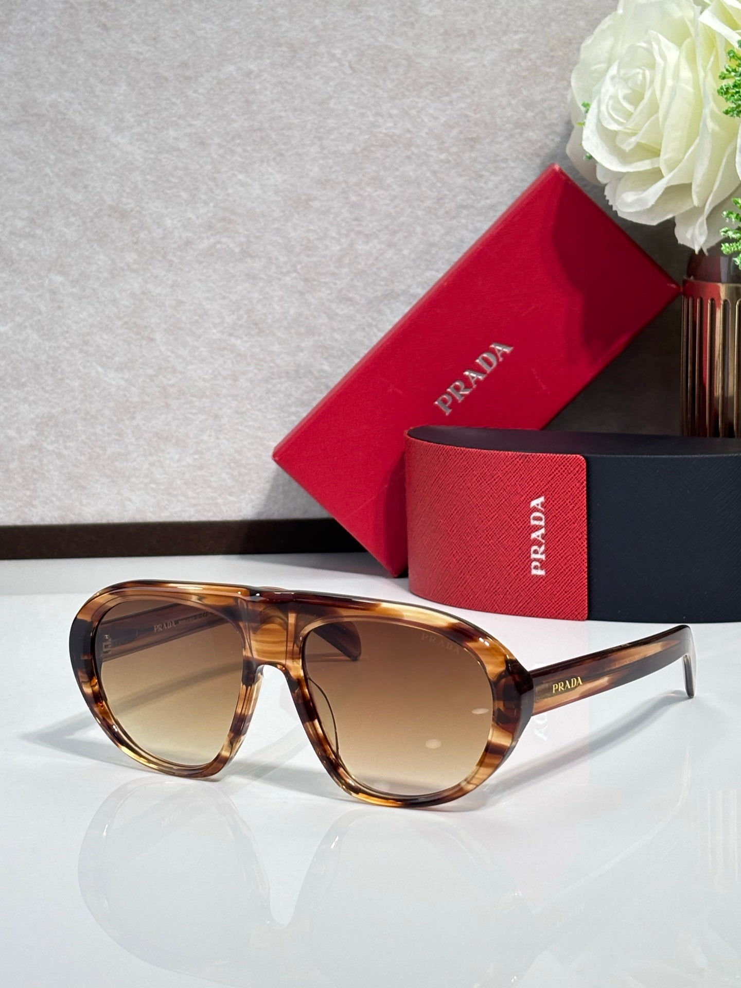 Prada glasses with tortoiseshell frames and warm brown-tinted lenses