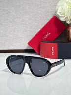 Prada glasses with black frames and dark gray-tinted lenses