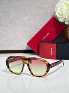 Prada glasses with tortoiseshell frame and tinted light-green lenses