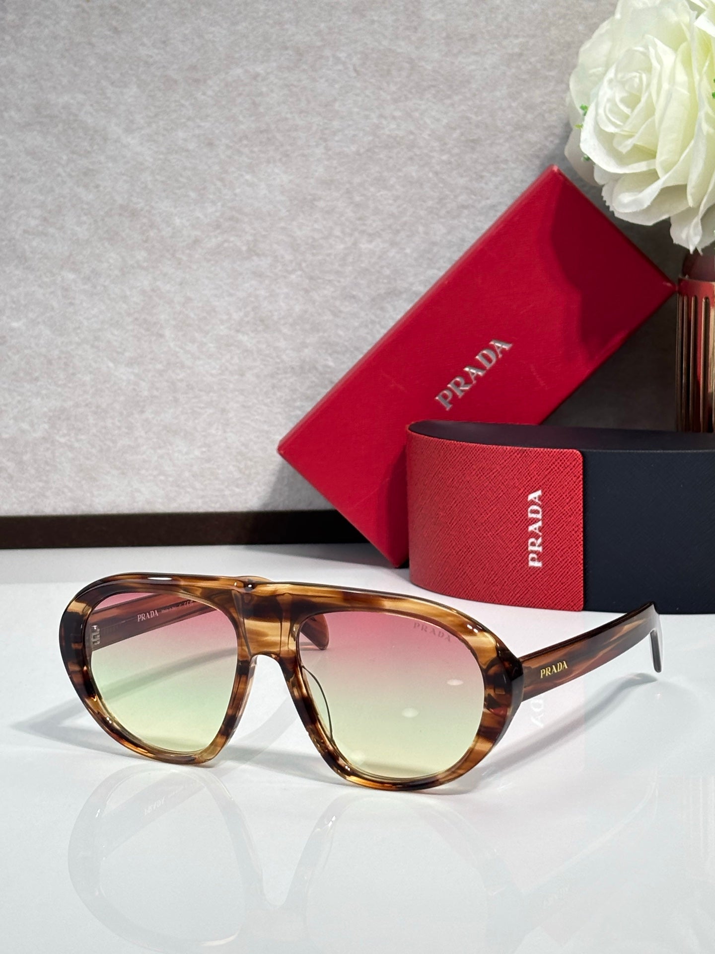 Prada glasses with tortoiseshell frame and tinted light-green lenses