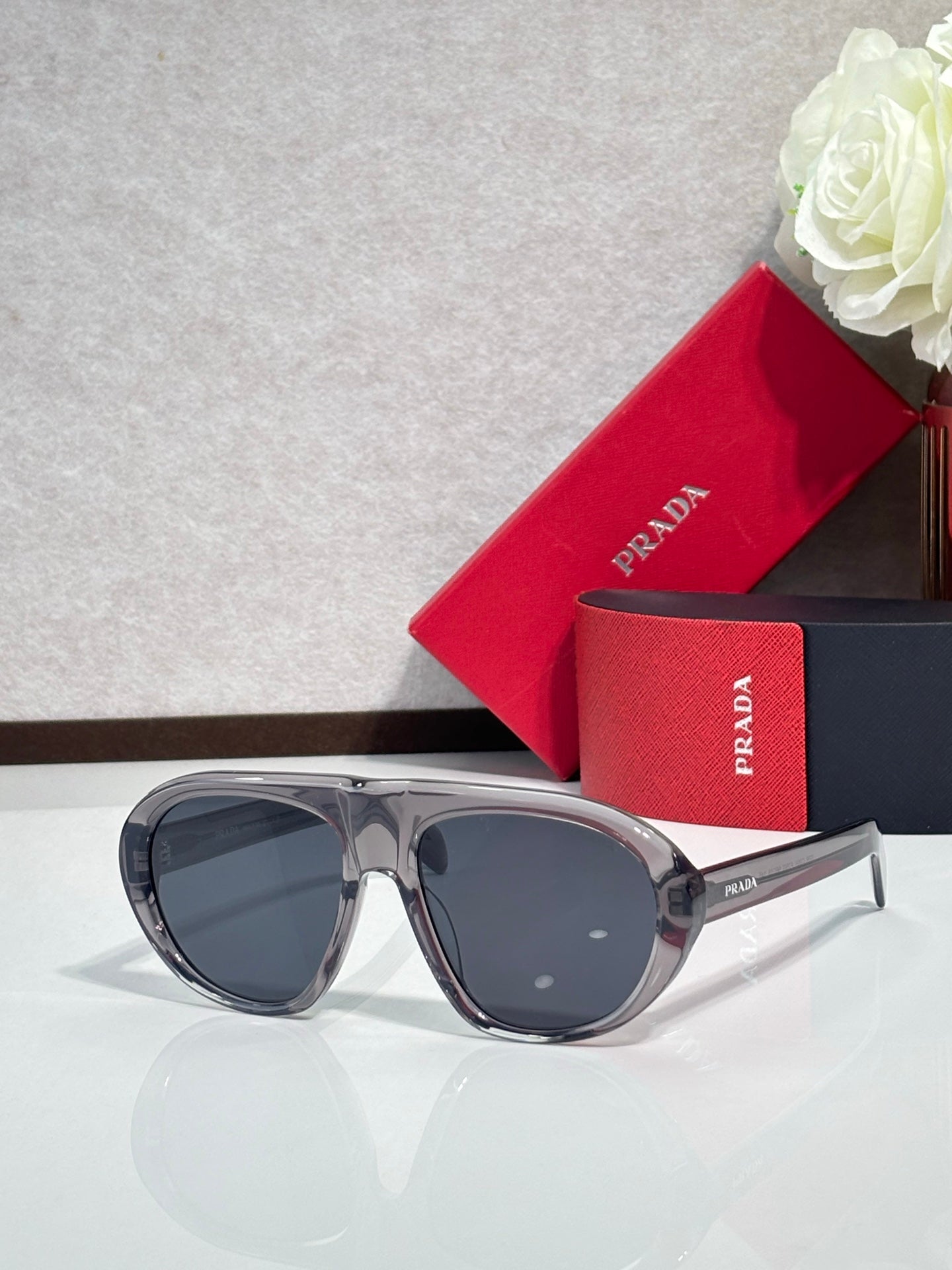 Prada glasses with gray frames and dark gray-tinted lenses