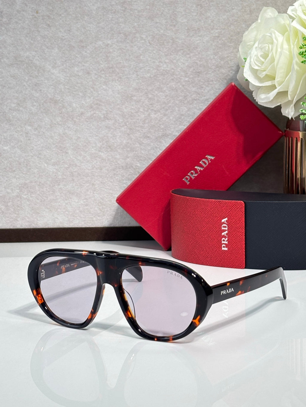 Prada glasses with tortoiseshell frames and clear-to-amber lenses