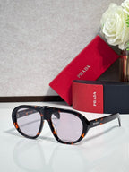 Prada glasses with tortoiseshell frames and clear-to-amber lenses