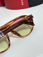 Prada glasses temple and lens close-up with tortoiseshell frame