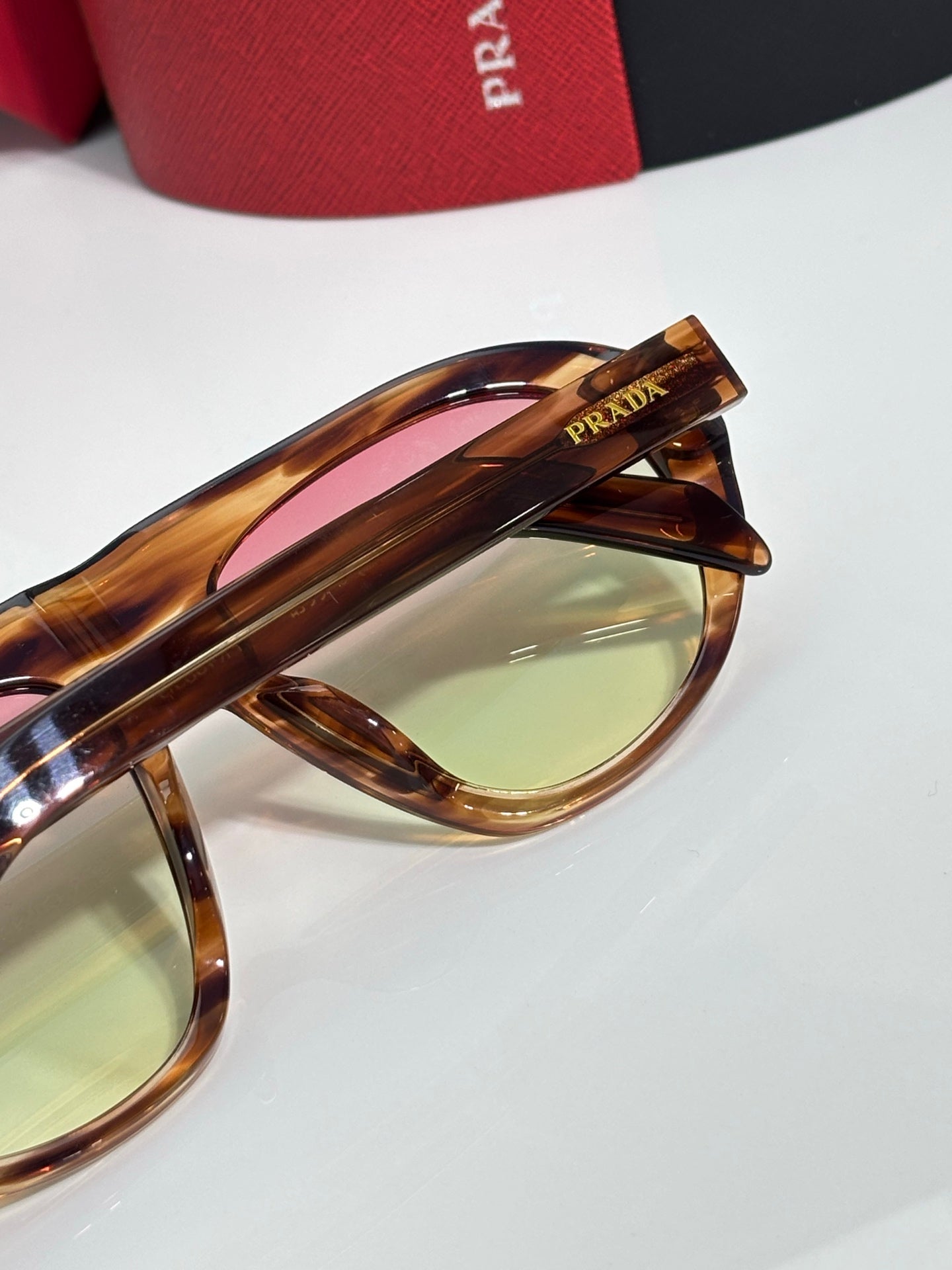 Prada glasses temple and lens close-up with tortoiseshell frame