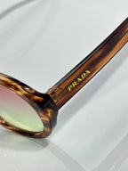 Prada glasses tortoiseshell temple with logo text and tinted lens